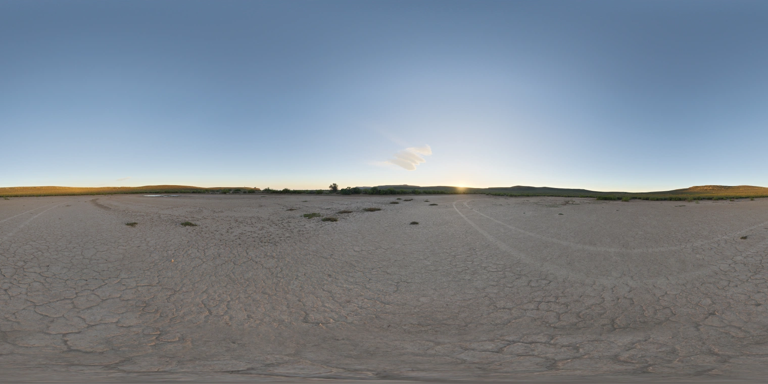 Unclipped, free 24K HDRI of a dry cracked pan at low sun. Clear blue sky, warm horizon glow, soft long shadows, crisp reflections, wide open landscape.