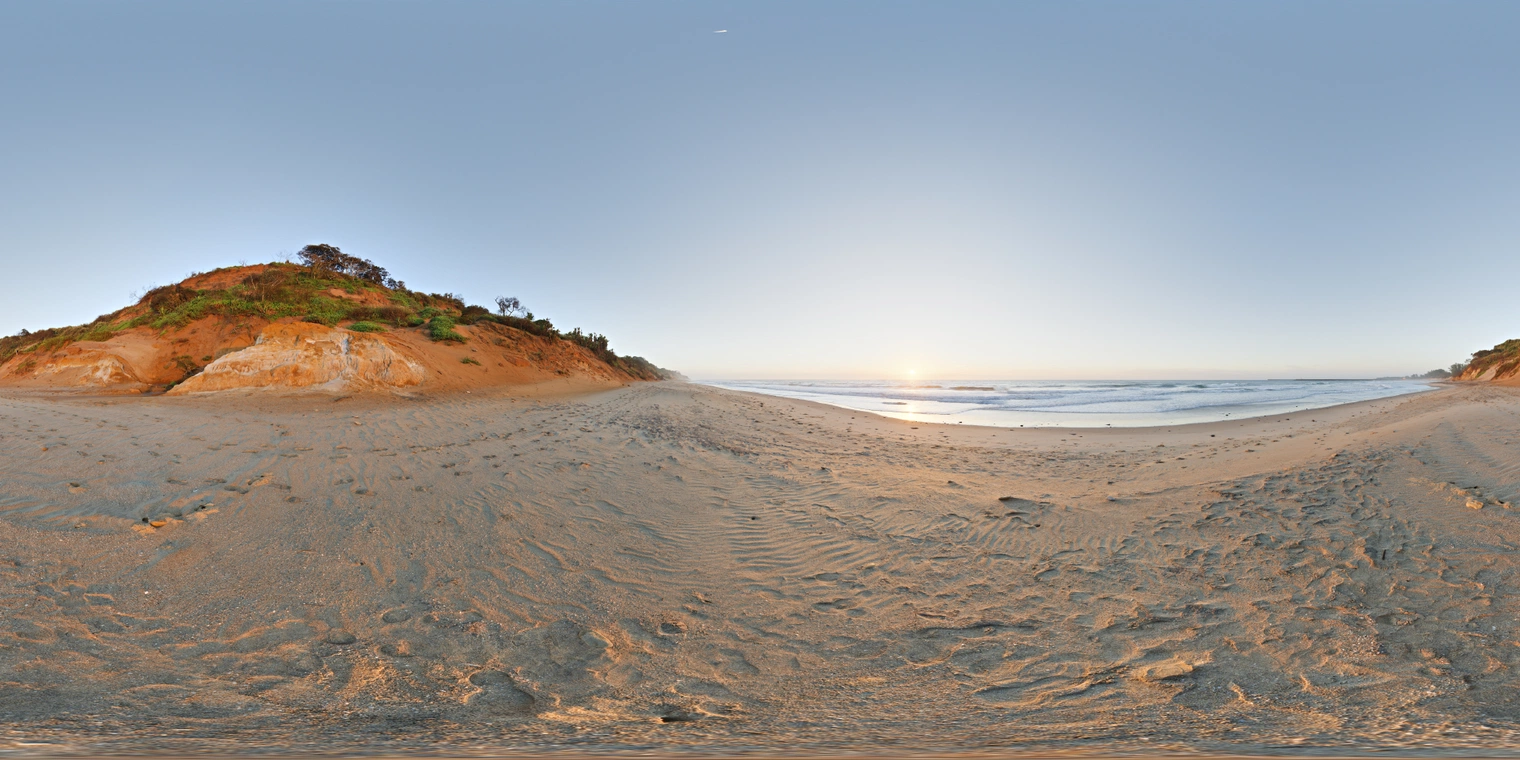 Unclipped, free 24K HDRI of a beach sunrise: clear sky, low sun over calm surf, warm golden highlights on sand, cool blue fill and long soft shadows.