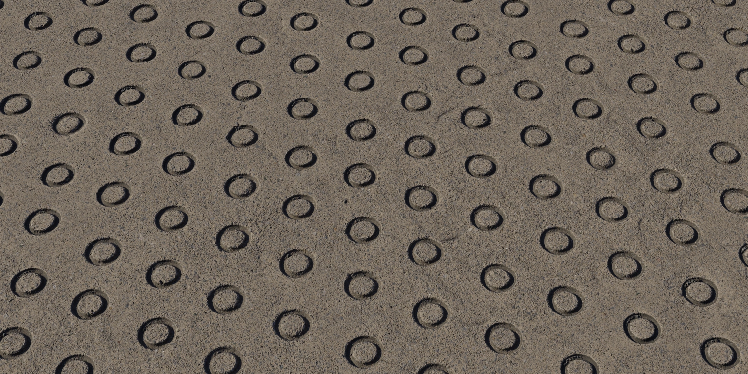 Free 8K texture: weathered anti-slip concrete with raised tactile dots, coarse gritty surface, scuffed, chipped and scratched exterior pavement material.