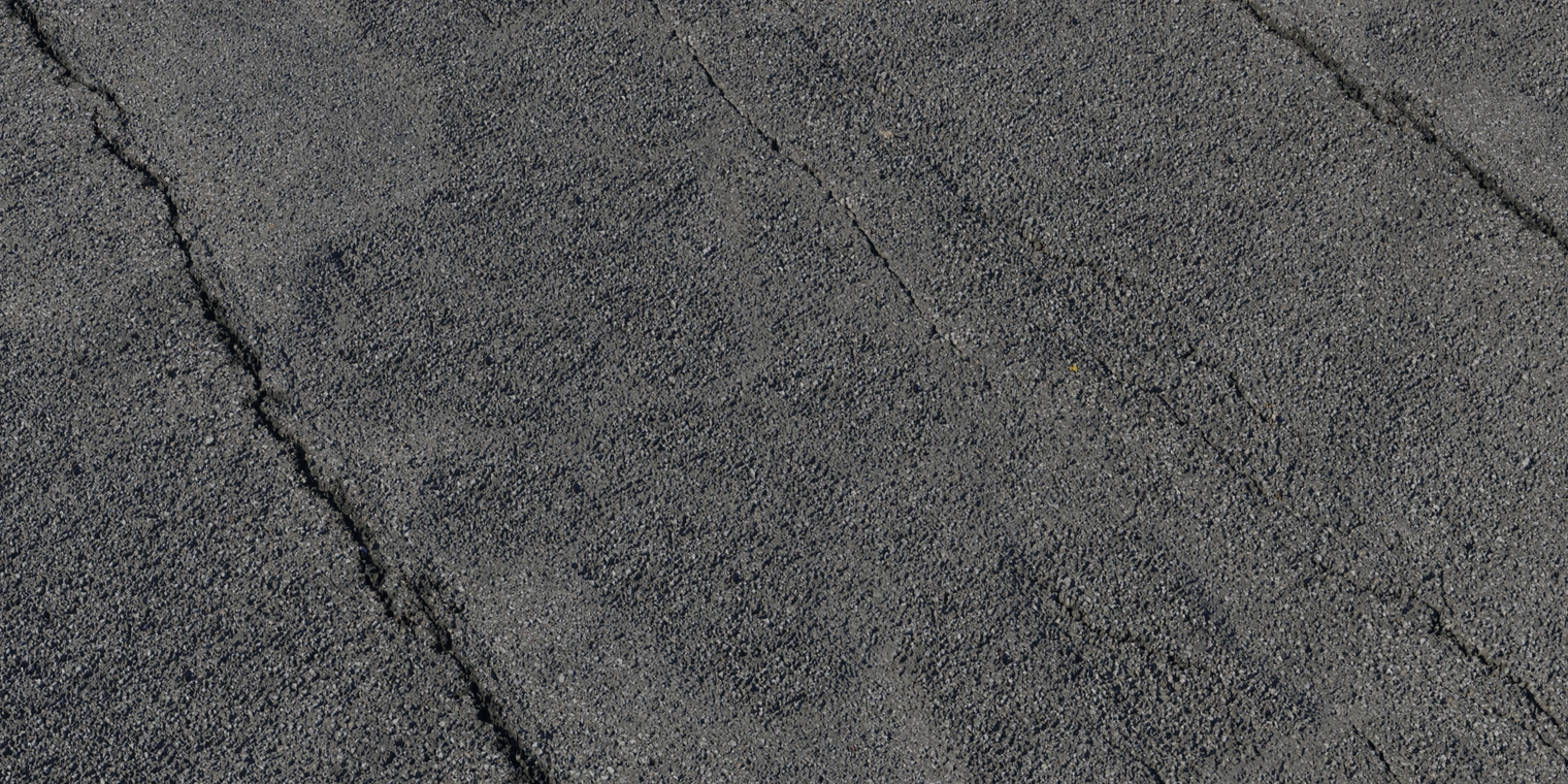 Free 8K texture of weathered grey asphalt: gritty coarse aggregate, subtle tar cracks, rough matte surface with uneven wear.