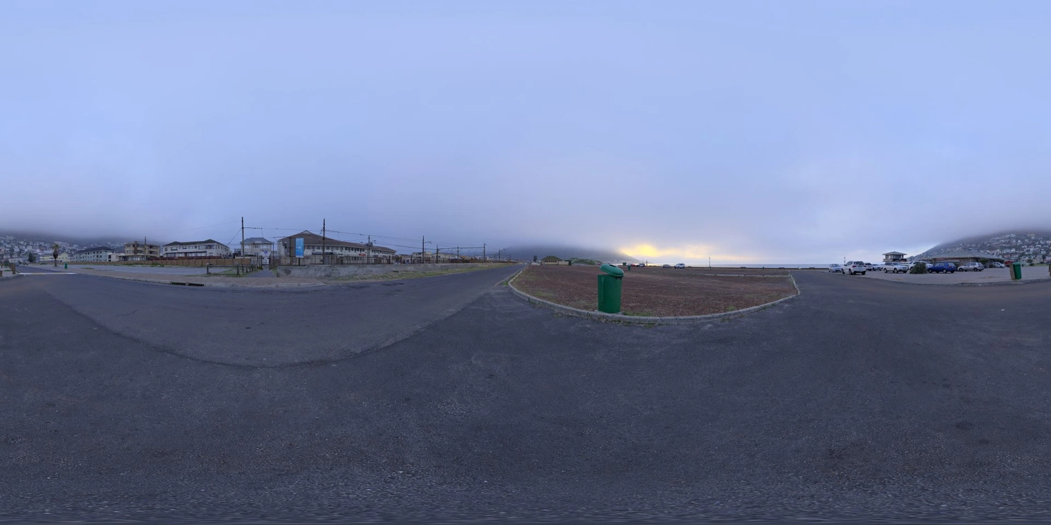 Free 16K, unclipped HDRI: soft, cool, foggy sunrise over a coastal parking lot - low-contrast natural light with a subtle warm glow on the horizon.