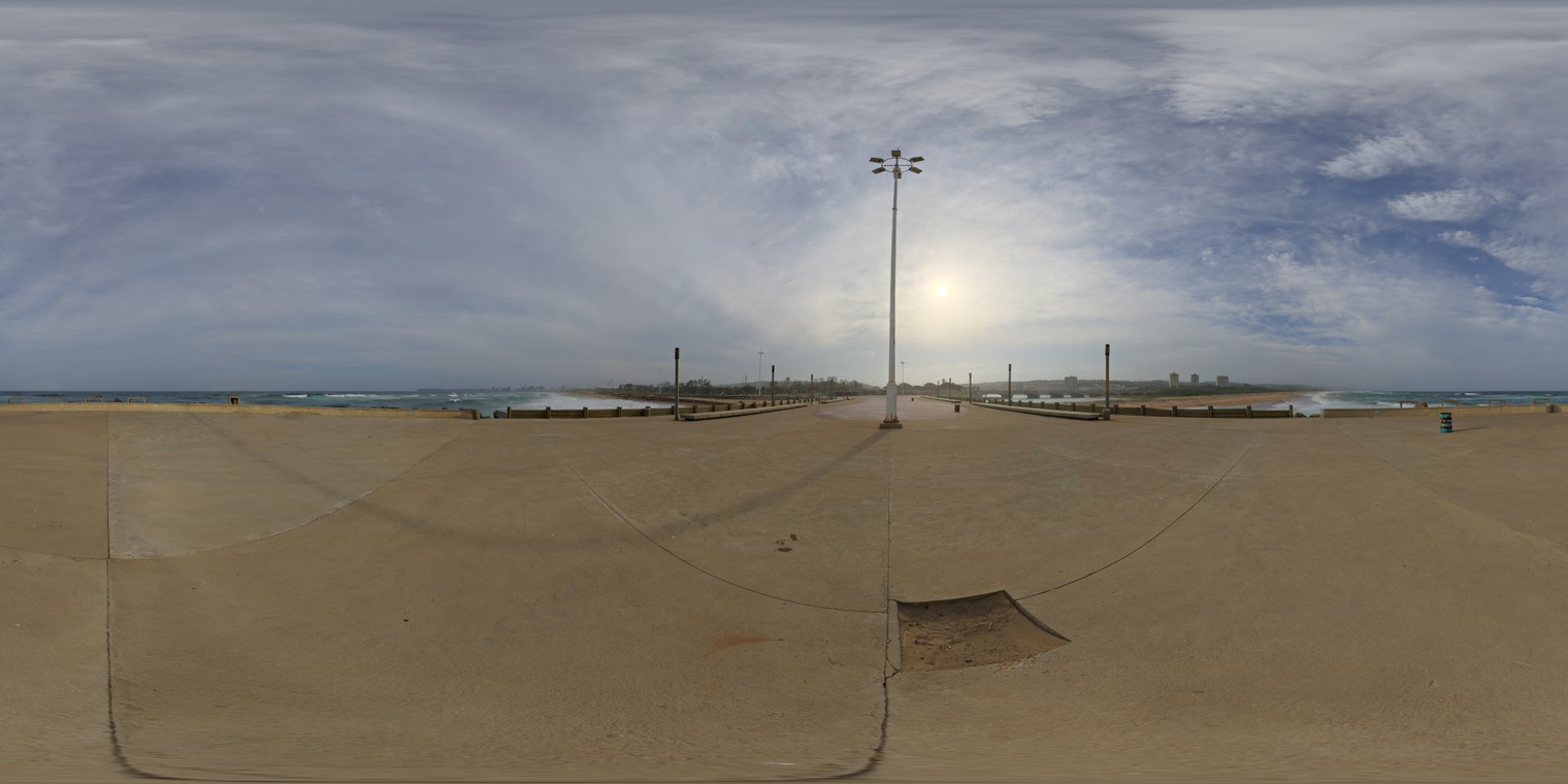 Free 16K, unclipped HDRI of a sunlit seaside pier at mid-morning/afternoon - partly cloudy sky, high contrast, cool ocean reflections and natural outdoor light.