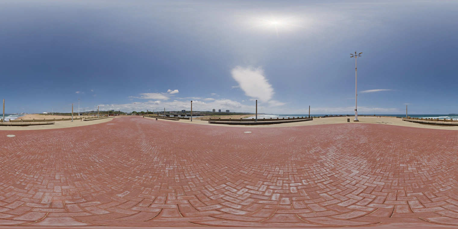 Unclipped, free 24K HDRI of a sunny beach promenade: clear blue sky, a few clouds, hard midday sun, high contrast, crisp reflections, blue lagoon on horizon.