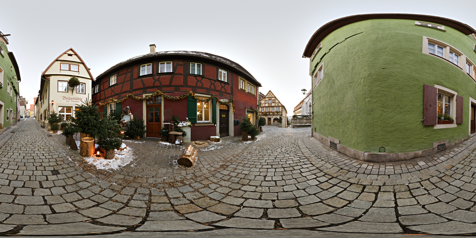 Unclipped, free 24K HDRI of a cobbled winter alley with timbered houses and garlands; soft overcast dusk, cool tones with warm window glows and gentle contrast.