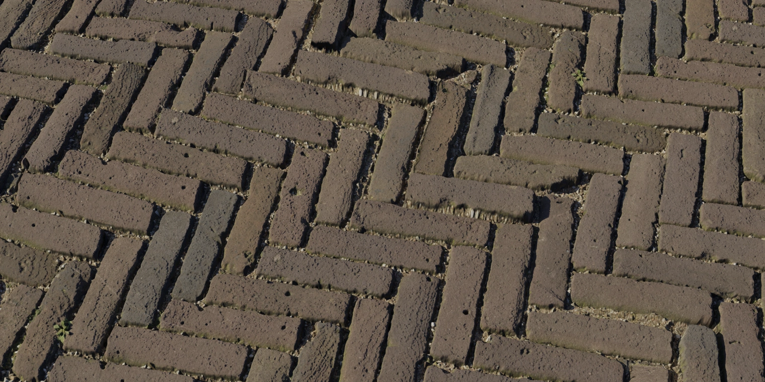 Free 8K texture of aged herringbone brick paving with diagonal repeat, rough worn bricks, dirty mortar and moss-filled joints in earthy brown tones.