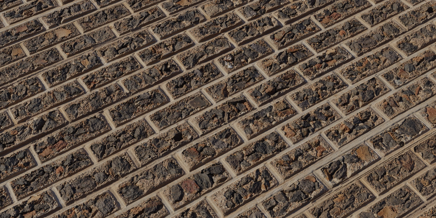 Free 8K texture: rough brick wall with chipped stone faces, cracked cement mortar and worn plaster surfaces.