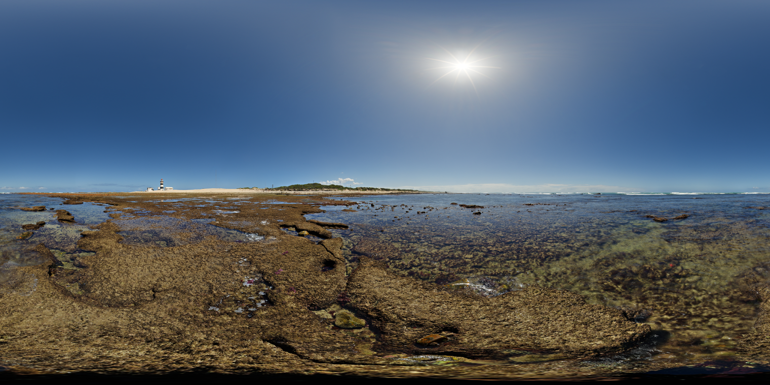 Unclipped, free 24K HDRI of shallow rock pools in clear midday sun: deep blue sky, crisp shadows, sparkling water, warm rocks.