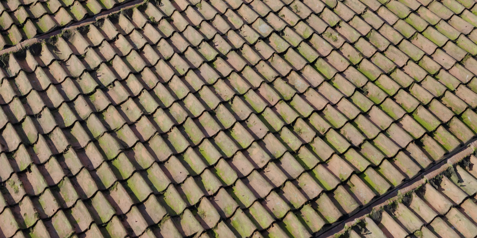 Free 8K material. Weathered ceramic roof tiles with chipped orange-red glaze, green moss patches, dirt-filled seams and subtle surface roughness.