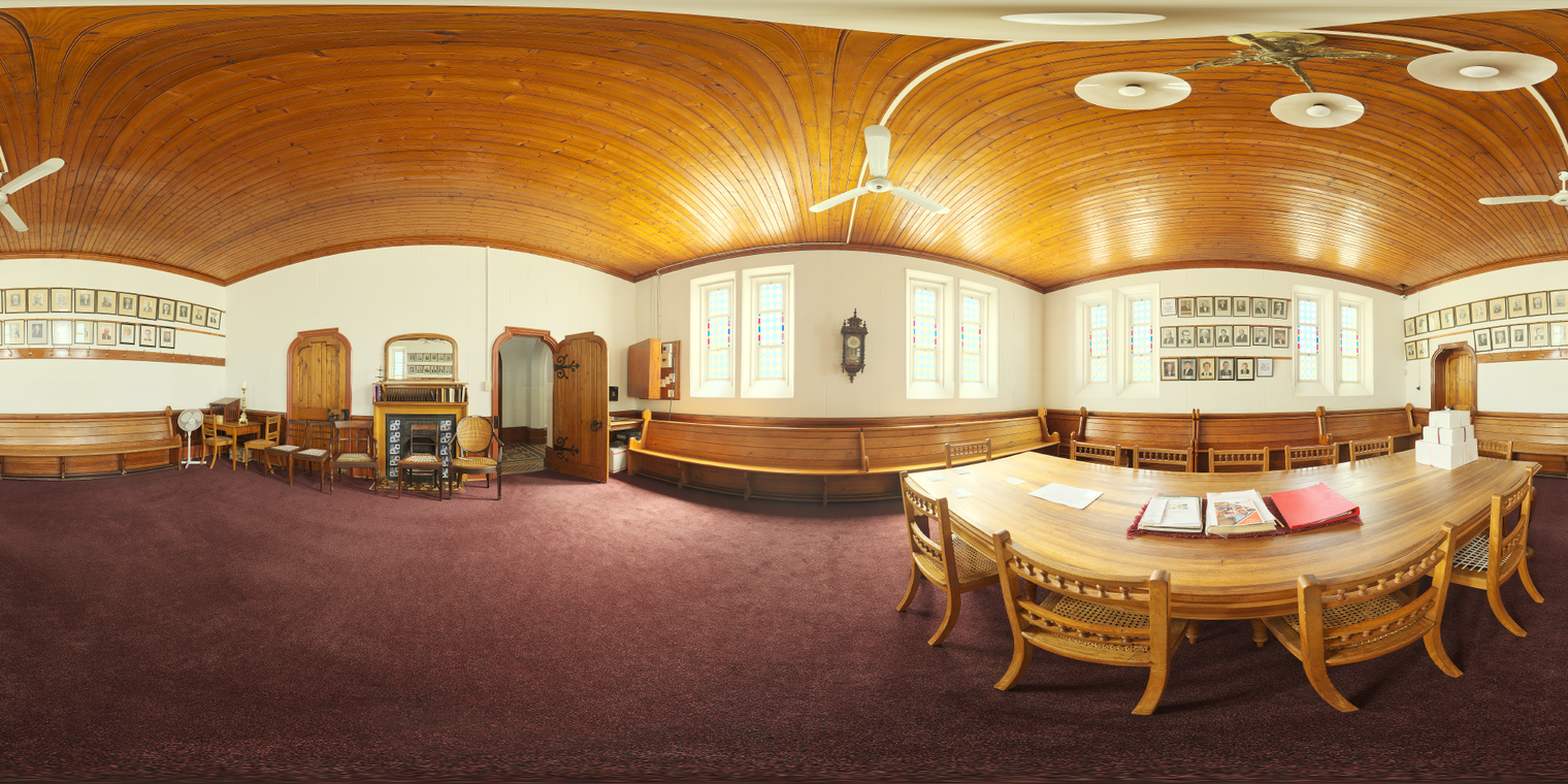 Free 24k unclipped HDRI: church meeting room with warm, low-contrast natural morning/afternoon light through stained-glass windows, soft ambient wood tones.