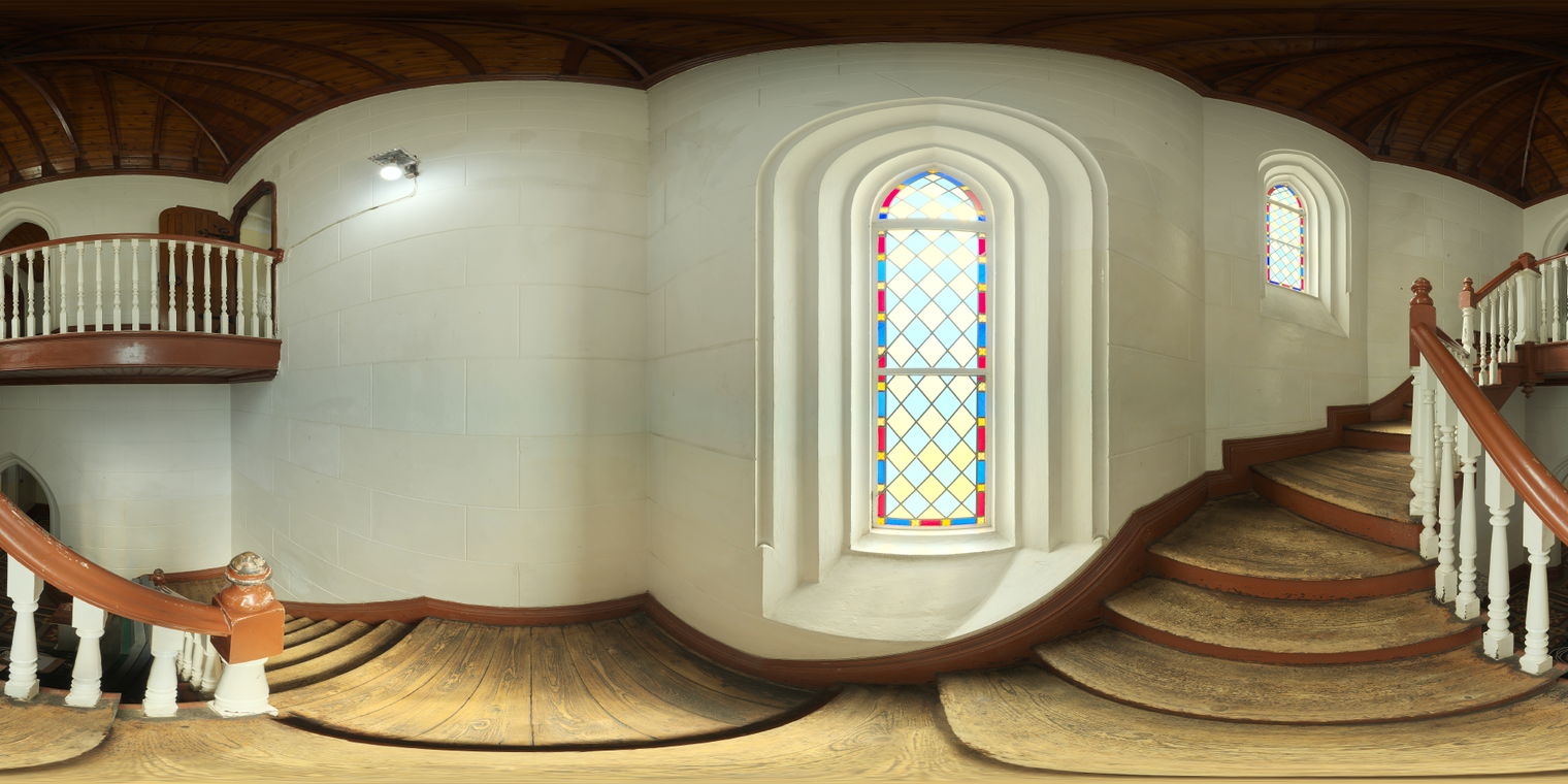 Free 24k unclipped HDRI of a sunlit church stairway with stained-glass windows, warm wood tones and soft colored light mixed with artificial highlights