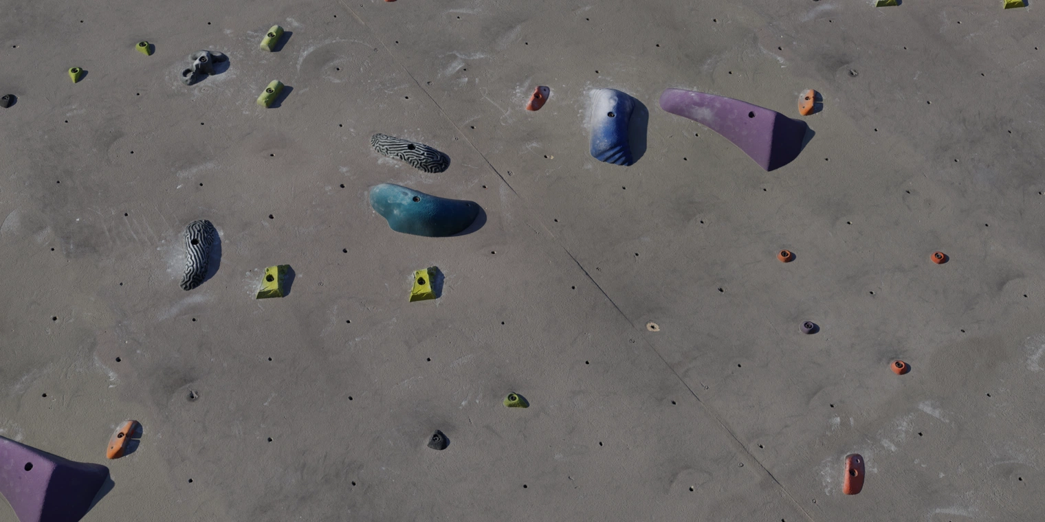 Free 8K climbing wall texture: even, rough plaster surface with bolt-on handholds, footholds and chalked grip, ideal for indoor gym and bouldering scenes.