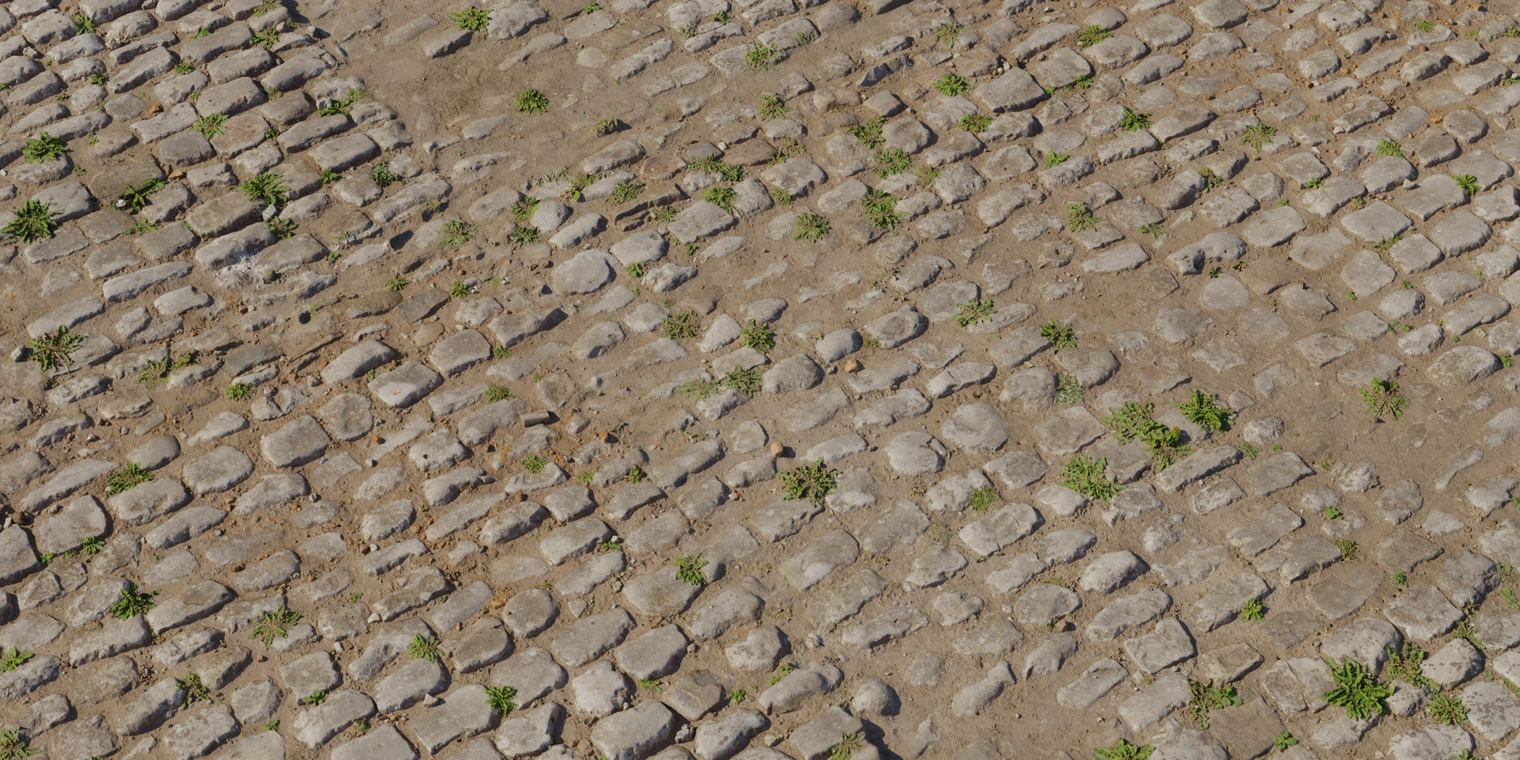Free 8K texture of aged cobblestone: rounded weathered stones set in dry muddy joints with cracked dirt and grass tufts, rough worn surface and earthy tones.