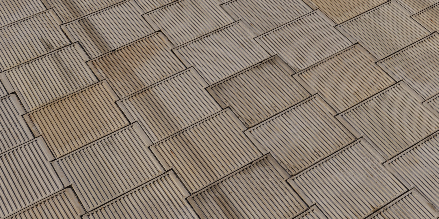 Free 8K texture of stamped concrete panels with corrugated grooves, weathered brown patina, visible seams, stains and chipped edges for a rough, timeworn wall.