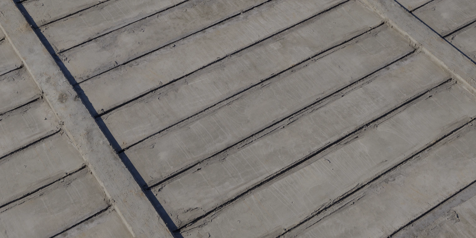 Free 8k material: weathered precast concrete slab wall texture with rough, discolored surface, horizontal panel joints, dirt streaks and patched cement.