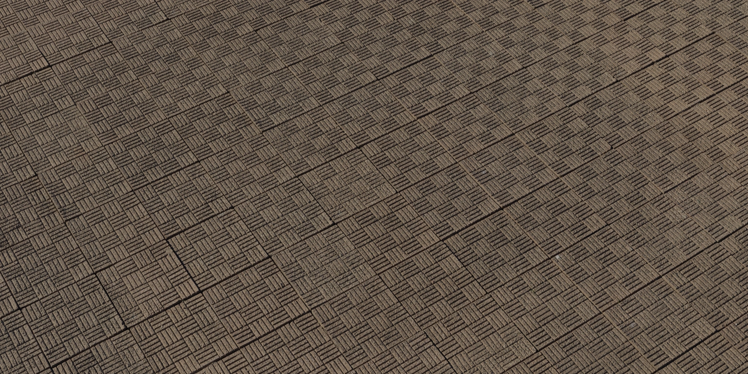 Free 8K texture: weathered stamped concrete tiles with a coarse, worn surface, repeating square basketweave pattern and visible grout lines.