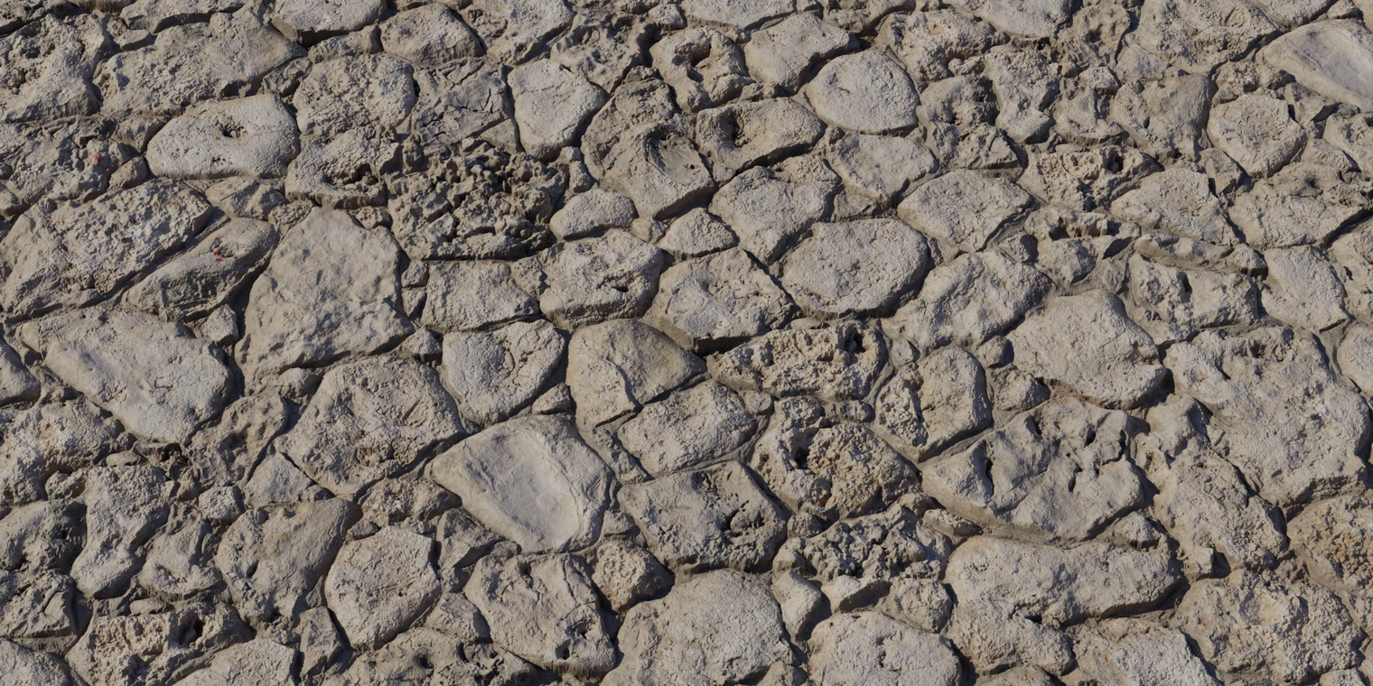 Free 8K texture of rough, chipped coral stone wall; beige, porous rock blocks with irregular mortar joints, weathered edges and cavities.