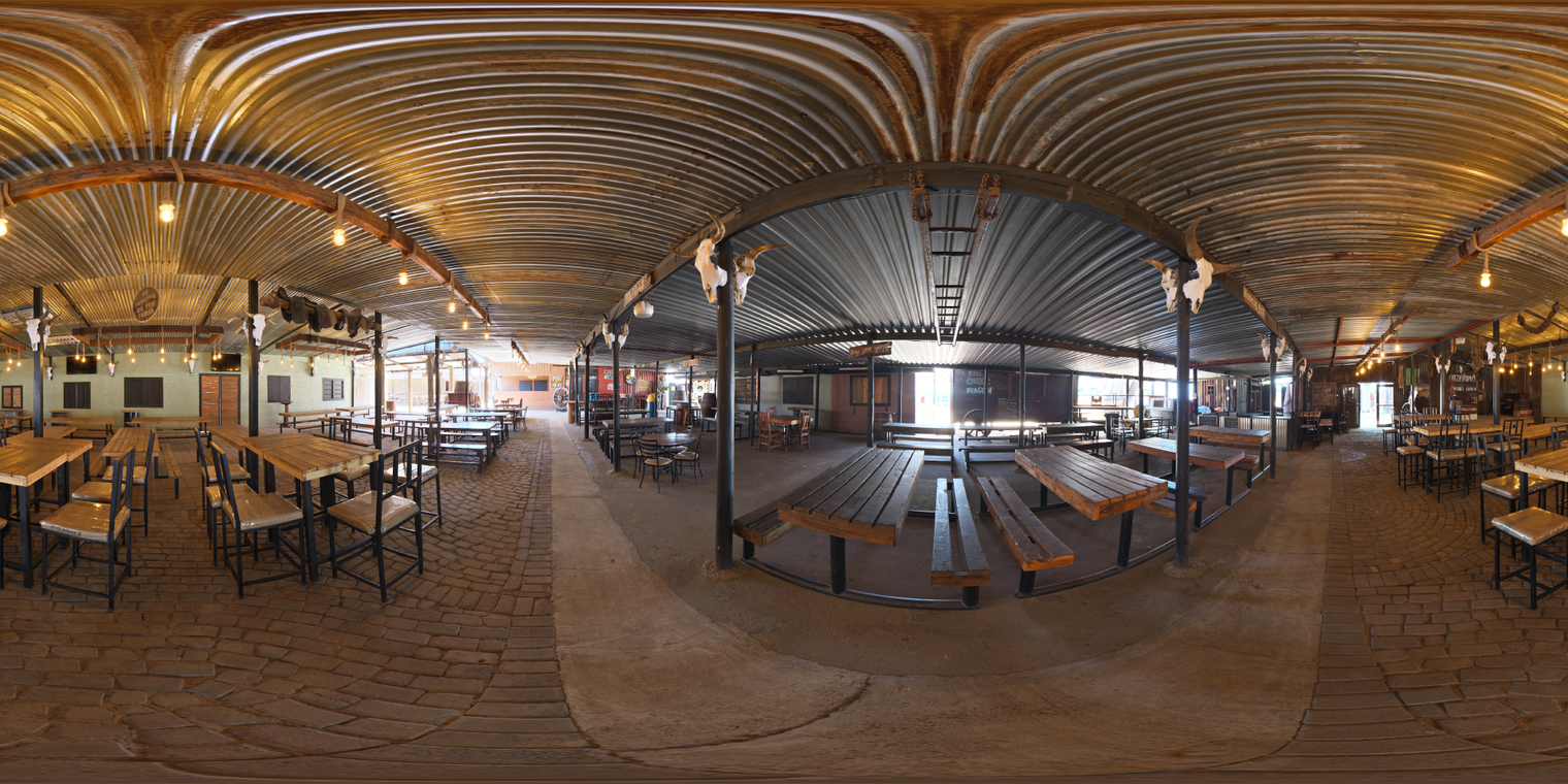 Unclipped, free 20K HDRI of a rustic cowboy hall: warm LED bulbs, corrugated roof, wood benches, soft shadows, cool daylight, and bright entrances.