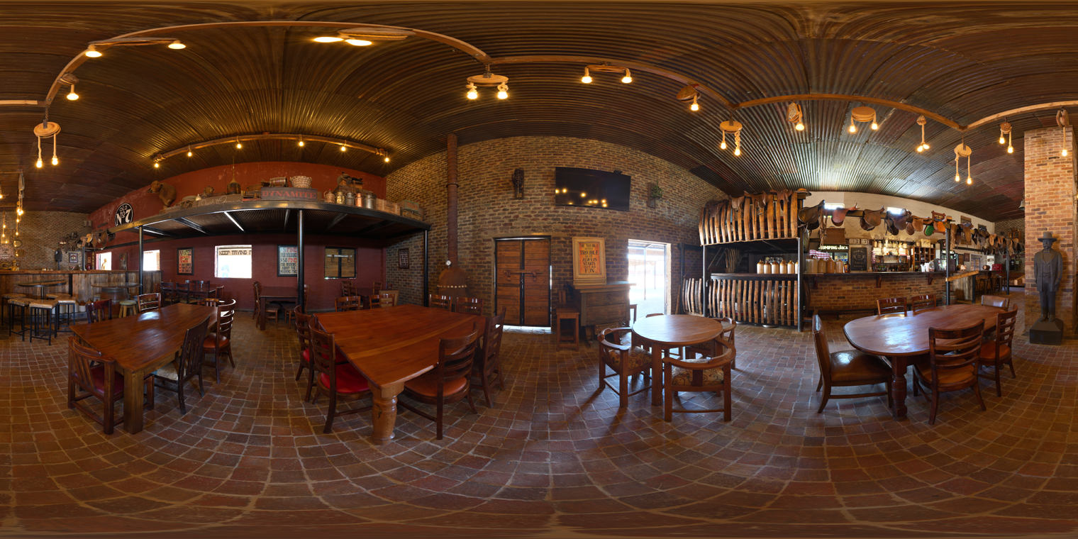 Unclipped, free 20K HDRI of a rustic saloon: warm tungsten glow, brick and wood, soft amber mood, gentle shadows, bright doorway highlights.