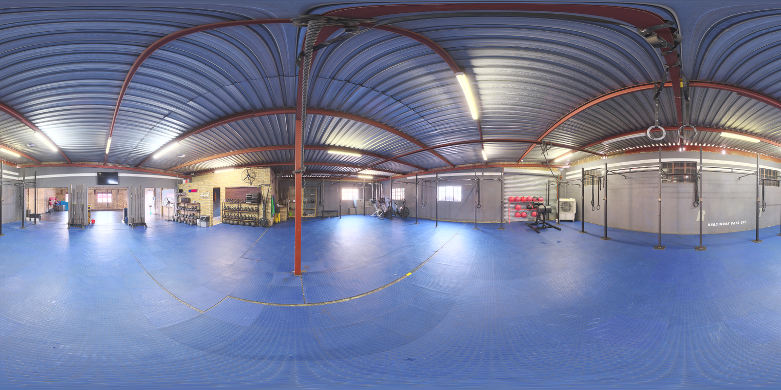 Free 20k unclipped HDRI of a CrossFit gym with cool fluorescent indoor lighting, medium contrast, blue rubber floor and metal-roof.