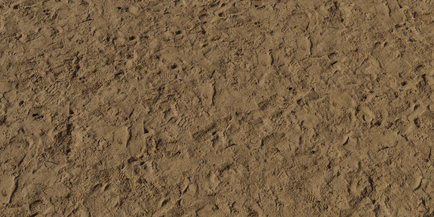 Free 8K damp sand texture. Coarse, moist brown grains with compacted ripples, fine granular detail, scattered pebbles and subtle sheen from wetness.