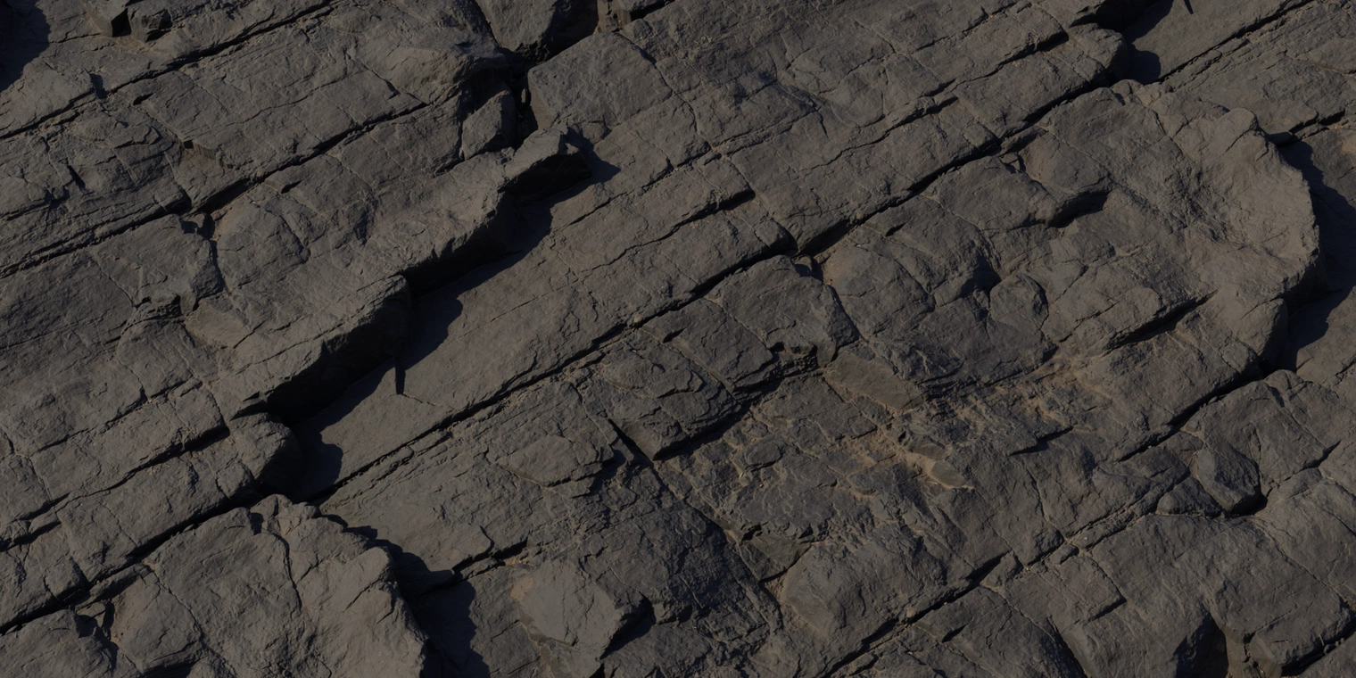 Free 8K texture of dark stratified rock with sharp fractures, deep crevices and layered plates. Matte, weathered stone with subtle earthy brown tones.