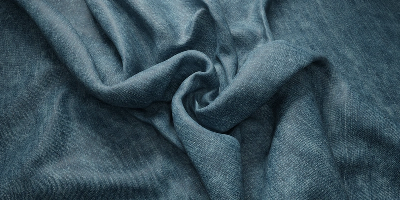 Free 8K denim texture with fine woven grain, subtle faded highlights and soft worn surface, showing realistic creases and folds.