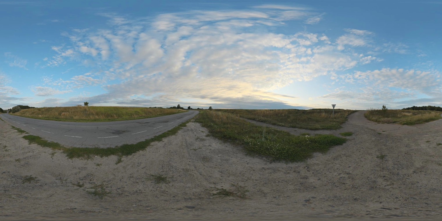 Free 16K unclipped HDRI: evening low sun with warm horizon glow, cool blue partly cloudy sky and soft directional natural light on asphalt road, dirt shoulders and grassy fields, medium contrast.