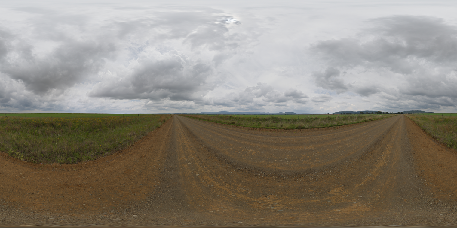 Free 24k unclipped HDRI of a rural dirt road under heavy overcast - soft, diffuse cool light, muted colors and broad, shadowless stratocumulus clouds creating a calm, moody atmosphere.