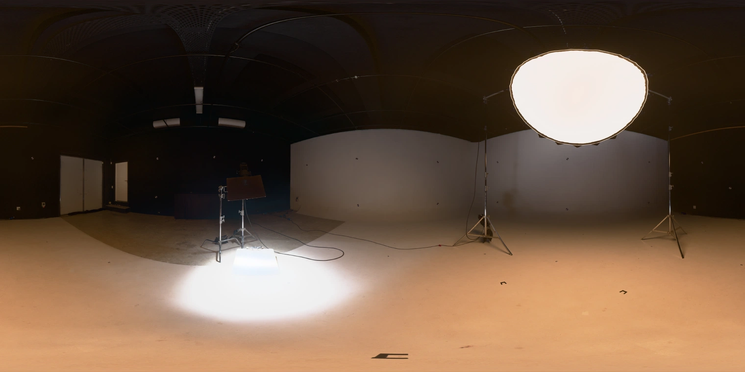 Free studio HDRI - warm, high-contrast umbrella key with floor reflector in a dark infinity cove; ideal for portraits, products, cinematic scenes.