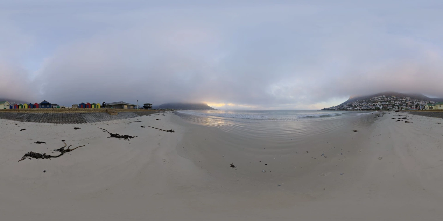 Unclipped, free 16K HDRI capturing Fish Hoek Beach at a soft, overcast sunrise with cool, low-contrast natural light and gentle ocean reflections.