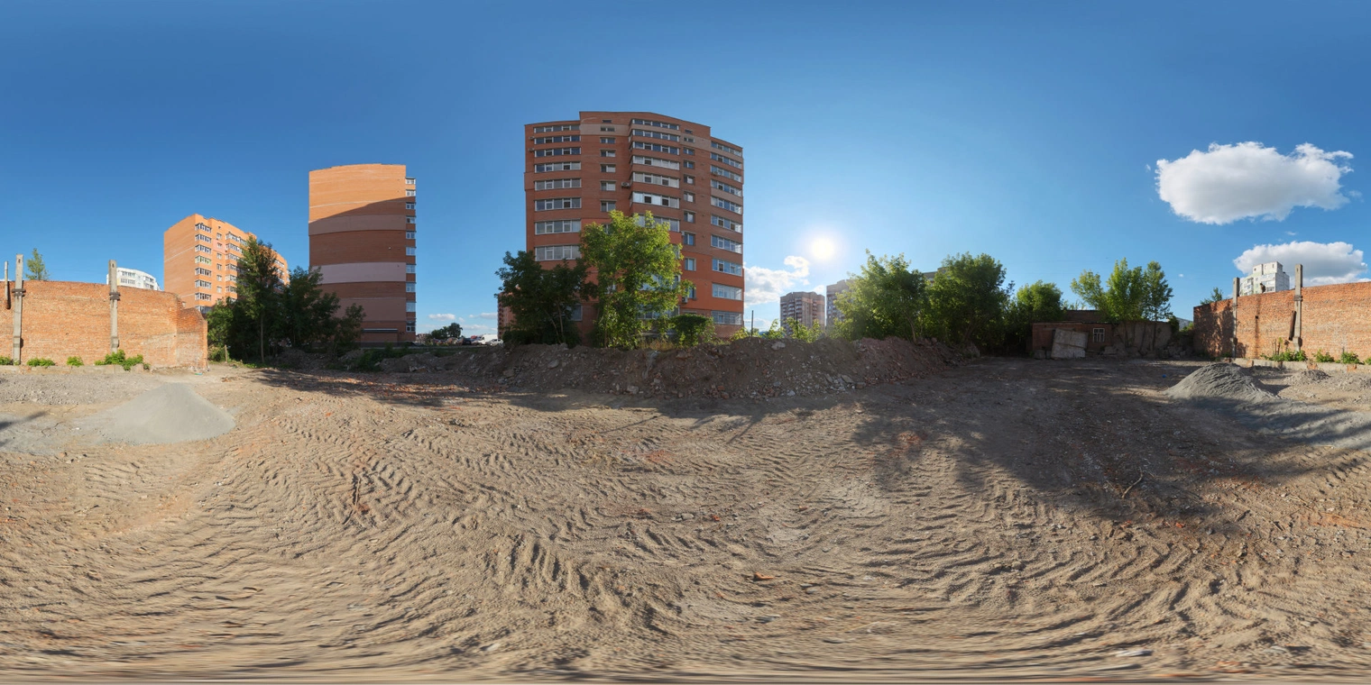 Unclipped 16K HDRI, free: sunlit urban rubble lot with brick and rutted dirt; bright partly-cloudy sky, afternoon directional natural light, high contrast.