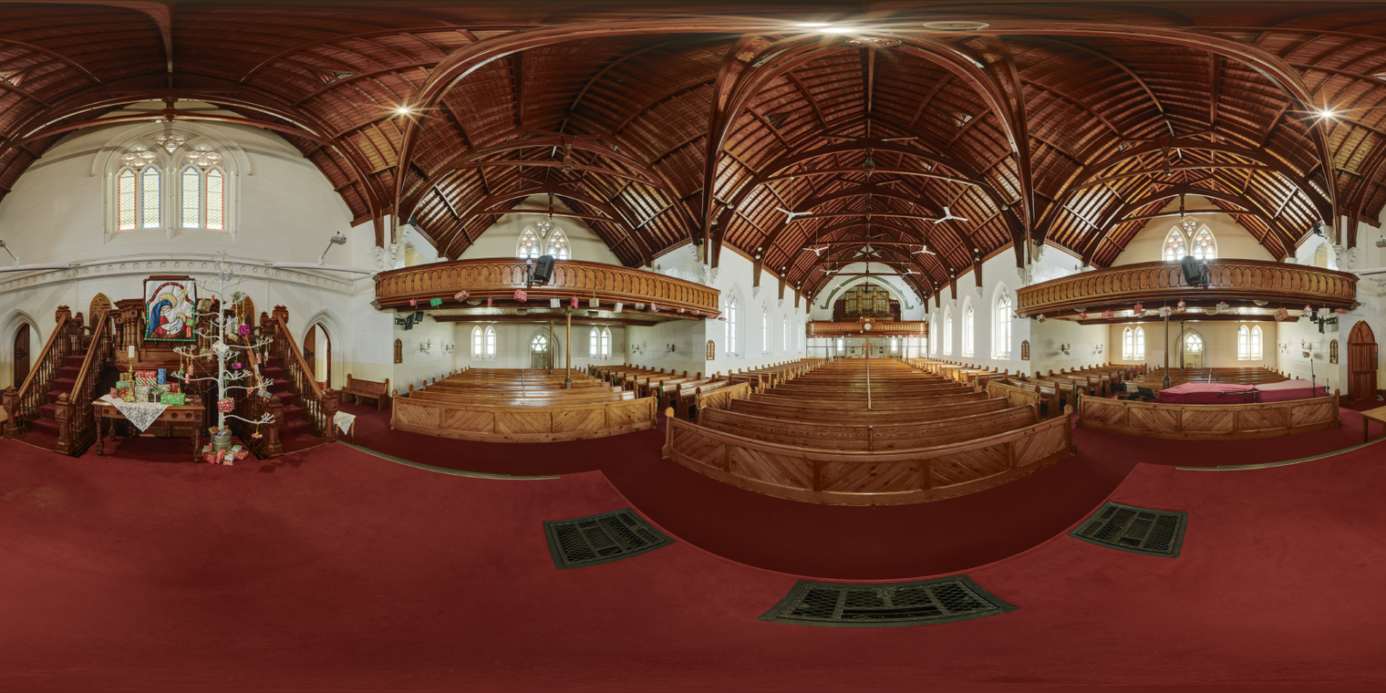 Unclipped, free 24K HDRI of a grand wooden church interior with warm lamps, soft window daylight, rich reds, balanced contrast and subtle speculars.