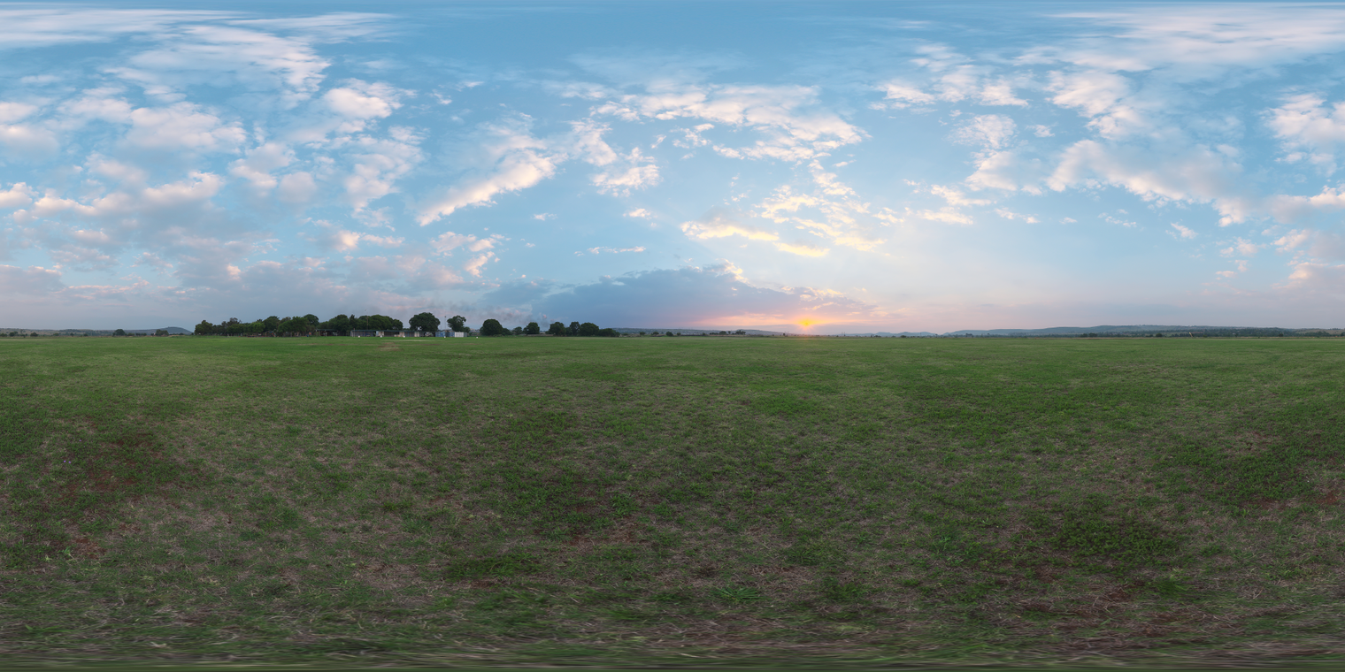Free, unclipped 20k HDRI. Wide-open grassland at sunset with a low golden sun, soft pastel sky and scattered clouds, cool-to-warm gradient and soft, even ambient lighting.