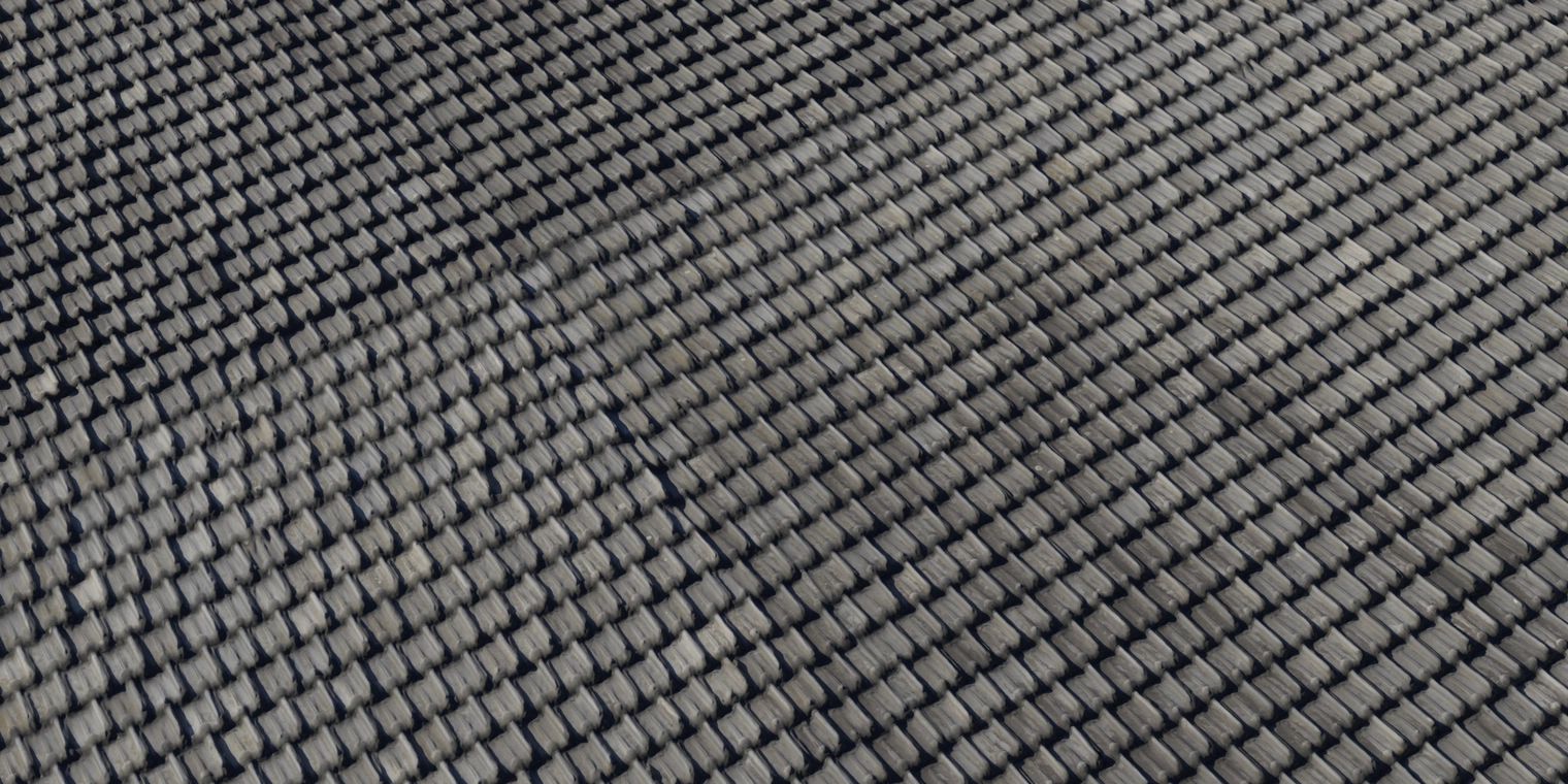 Free 8K texture. Clean dark-gray interlocking roof tiles with subtle satin sheen, fine surface grain, and crisp, slightly weathered tile edges.