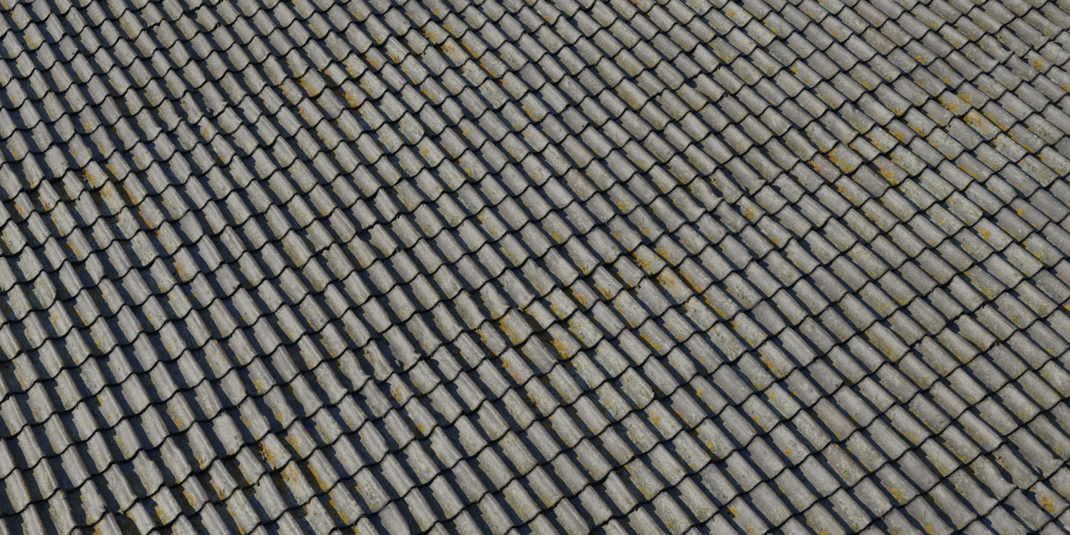 Free 8K texture of grey ceramic overlapping roof tiles, weathered and damp with moss patches, chipped edges and a gritty, low-gloss ceramic surface.
