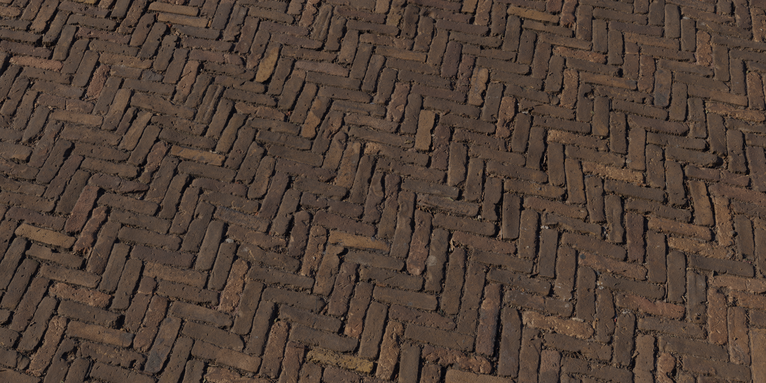 Free 16K texture of worn herringbone brick pavement with weathered, rough surfaces, visible mortar joints and subtle dirt and moisture-darkened crevices.