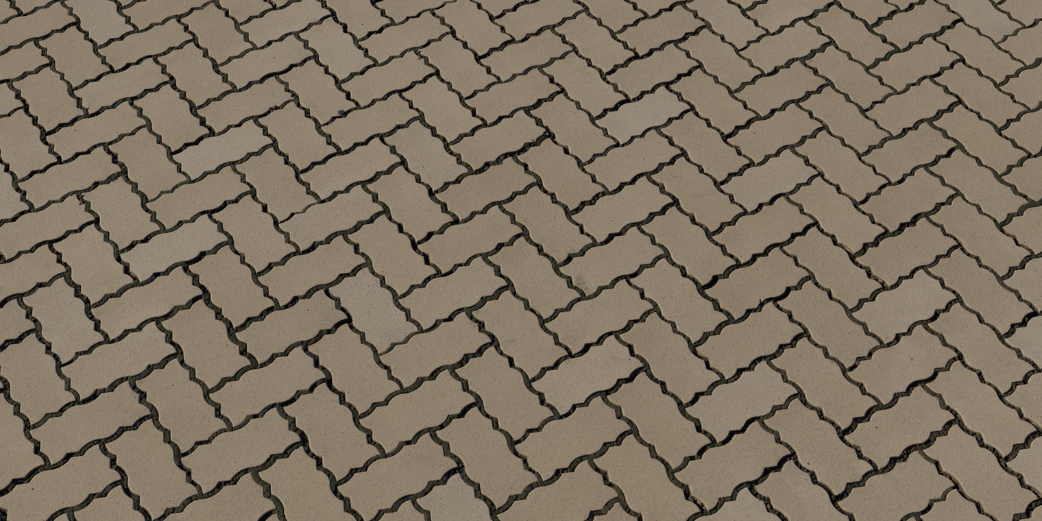 Free 8K texture of herringbone interlocking bricks - coarse concrete pavers, rounded worn edges, subtly rough surface, and dark recessed joints.
