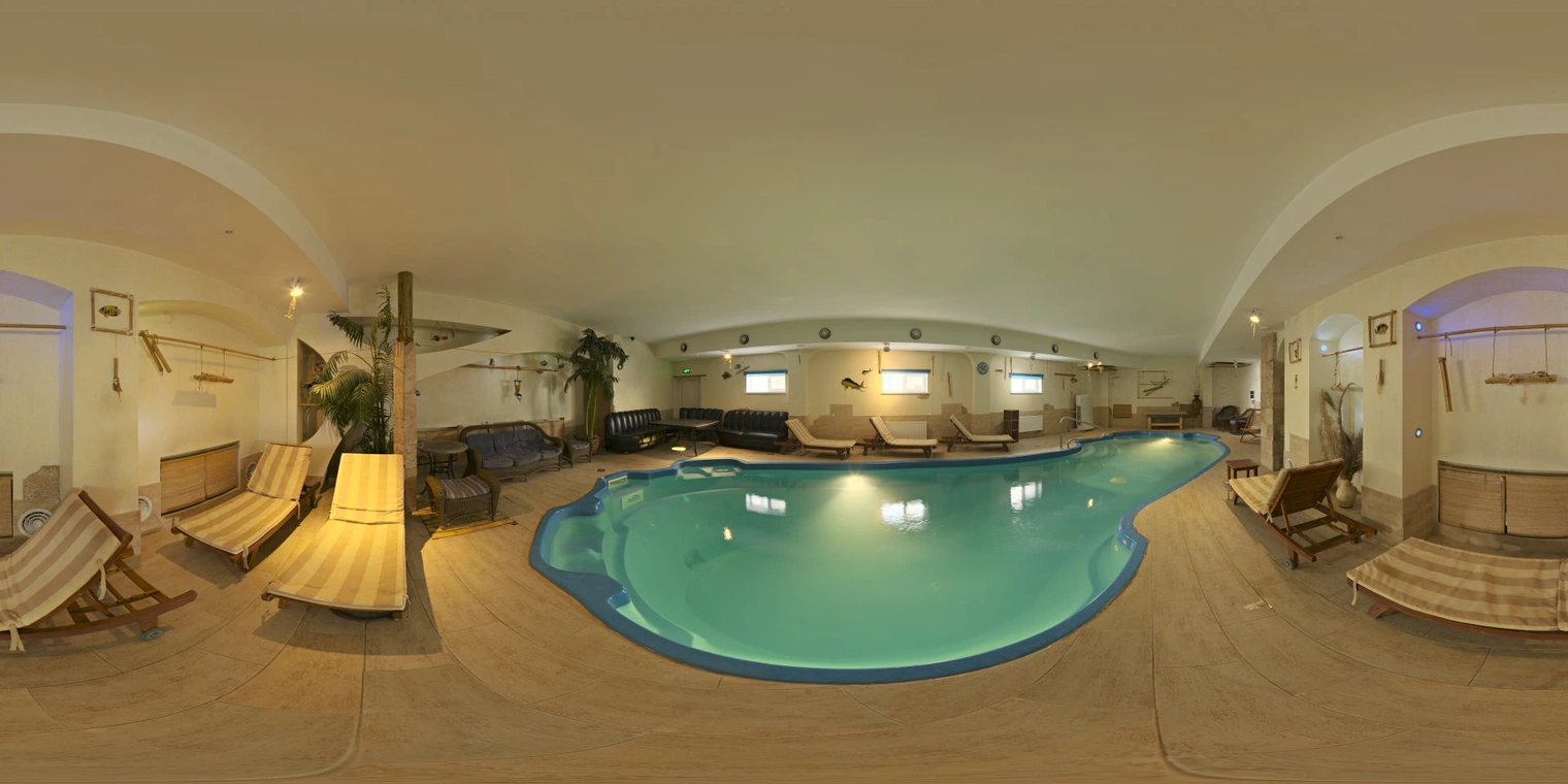 Free 17K, unclipped HDRI of an indoor pool with warm, low-contrast artificial lighting, soft reflections on turquoise water and a calm, cozy atmosphere.