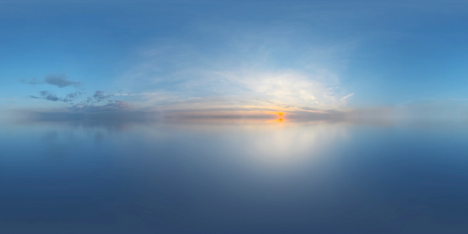 Free 16K, unclipped HDRI showing a calm industrial sunset, cool blue skies with partly cloudy, medium-contrast lighting and a low warm sun casting soft glow.