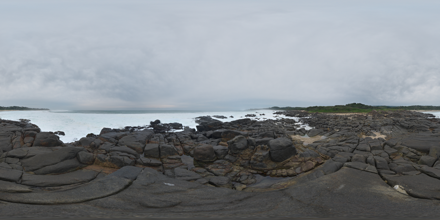 Unclipped, free 20K HDRI of a rocky coast at high tide under heavy overcast sky. Soft diffuse light with bright surf and dark wet stones.