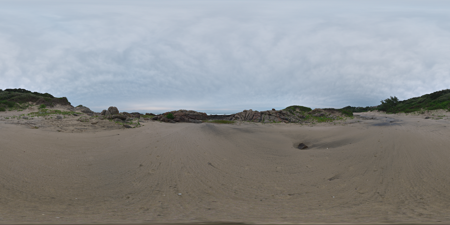 Unclipped, free 20K HDRI of a sandy beach with rocky dunes under thick overcast sky. Cool, low-contrast light, soft sky reflections, muted greens and browns.