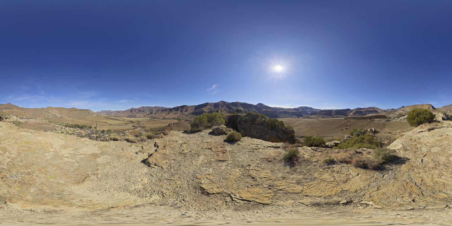 Free unclipped 16K HDRI capturing clear mid-morning sun over a rocky mountain valley, high-contrast natural light with crisp blue sky and long shadows.