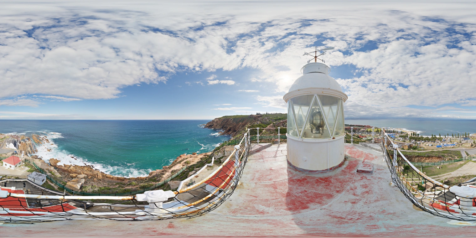Free 24K unclipped HDRI of a lighthouse rooftop over a rocky coast, bright midday sun with scattered clouds, crisp shadows and cool sea reflections.
