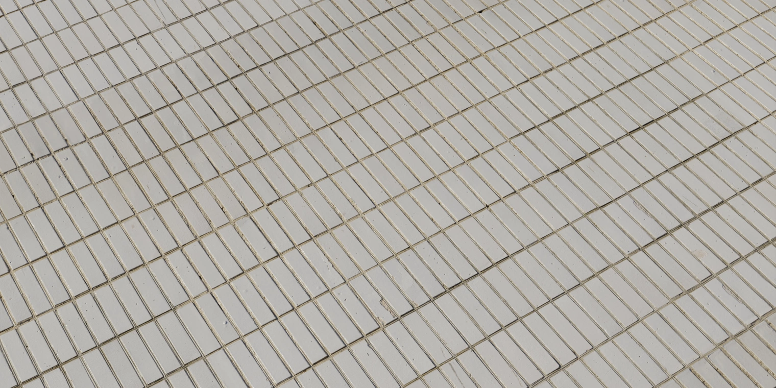 Free 16K texture: long white rectangular tiles with scuffed, chipped and discolored surfaces and worn grout - aged, minimalist, grungy wall or floor material.