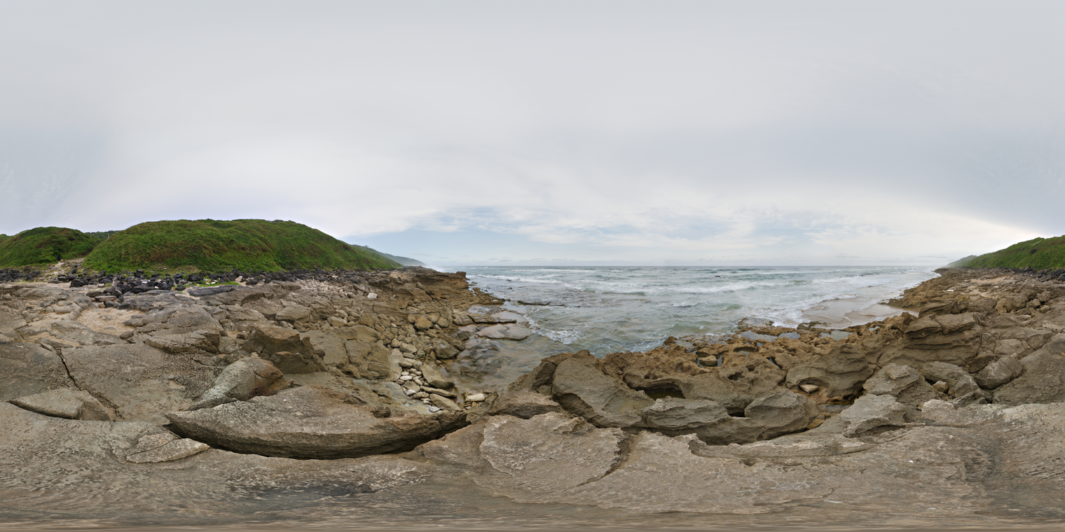 Unclipped, free 24K HDRI of a rocky shoreline under bright overcast skies. Soft, even daylight with cool tones, low contrast.