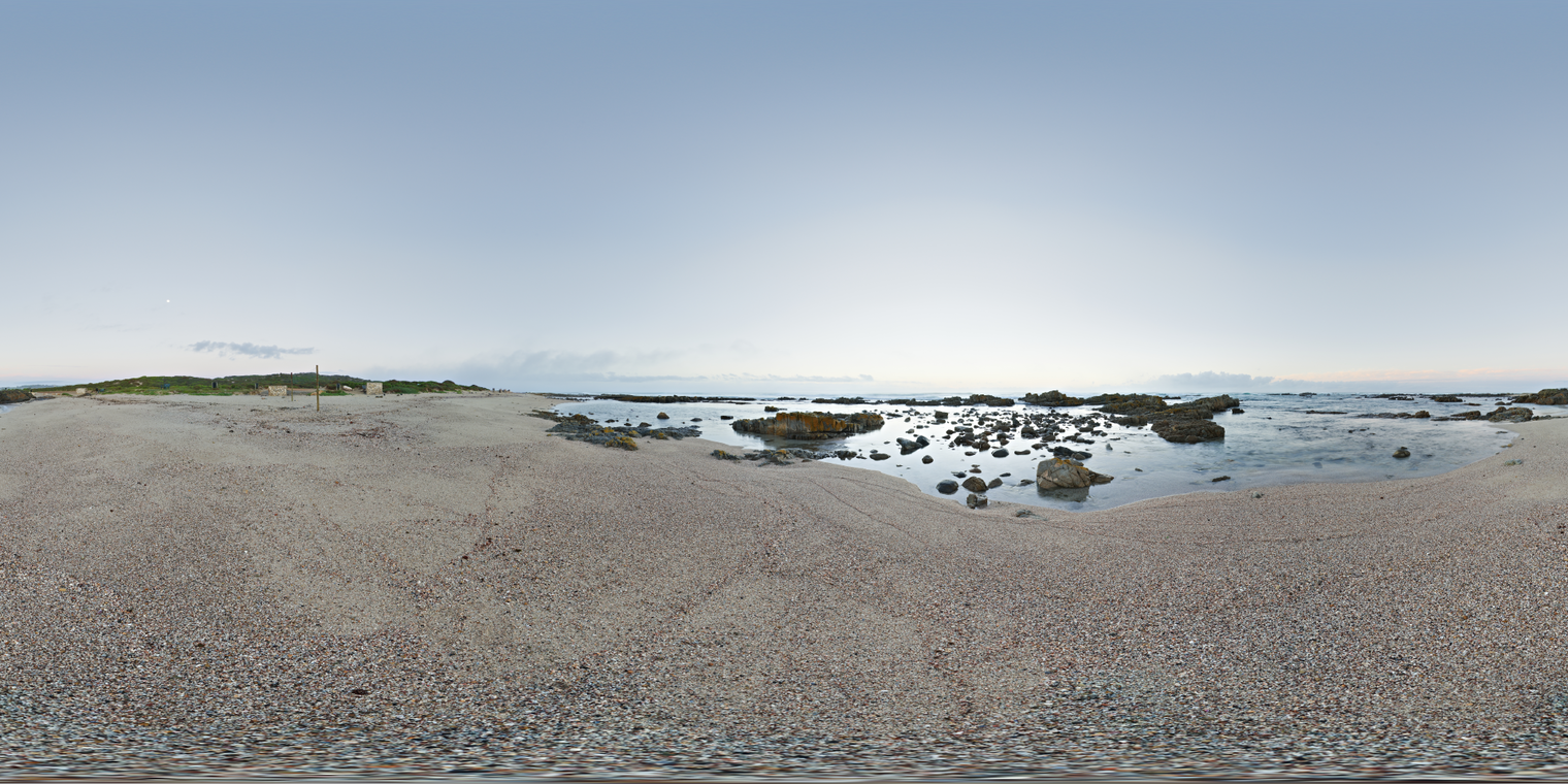 Unclipped, free 24K HDRI of a pebbly shore at low tide. Cool blue sky, bright horizon glow, soft neutral lighting and crisp reflections on wet rocks.