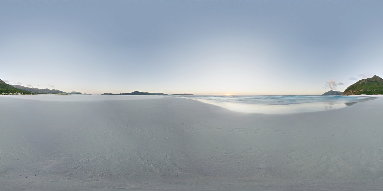 Unclipped, free 24K HDRI of a calm beach at sunset: pale blue sky, warm sun on the horizon, soft low-angle light, long gradients, and wet sand reflections.