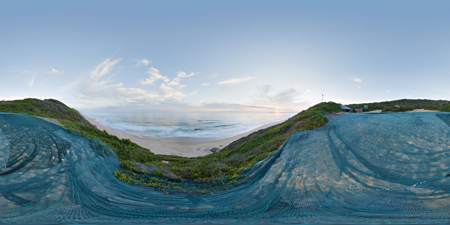 Unclipped, free 24K HDRI of a dune ridge above an ocean beach at low sun. Pastel sky with thin clouds, warm horizon glow, cool fill, soft balanced shadows.