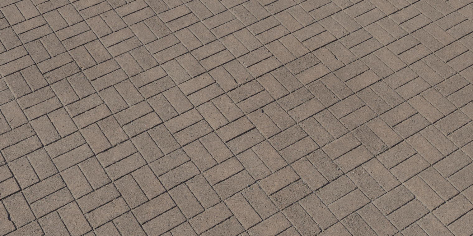 Free 8K texture: patterned brown brick paving with rectangular units in a basketweave layout, rough matte surface, subtle wear and narrow grout lines.