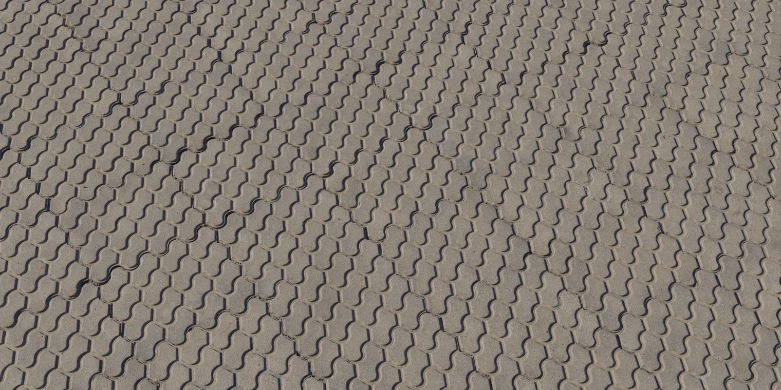 Free 16K texture: interlocking concrete pavers with a weathered, slightly rough surface, shallow grout lines and subtle dirt and wear.